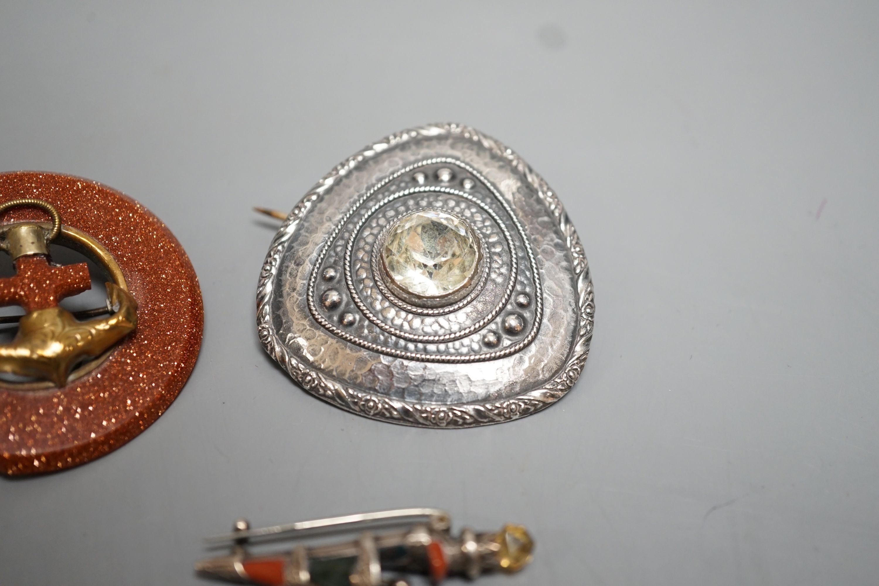 A white metal and Scottish hardstone set dirk brooch, 37mm and two other brooches.